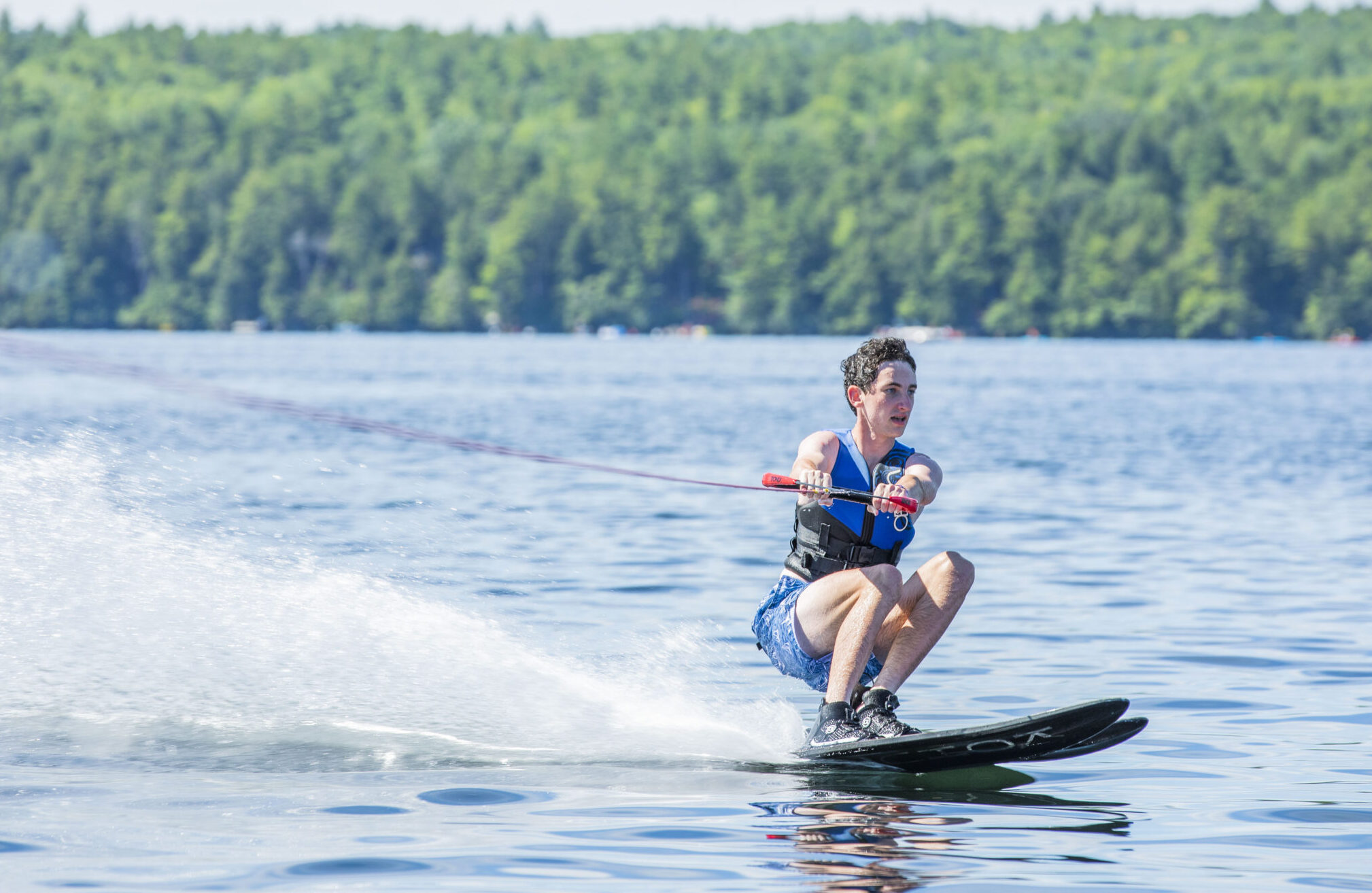 A Kamp Kohut camper enjoying water skiing on Thompson Lake in Oxford, Maine