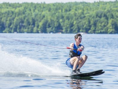 A Kamp Kohut camper enjoying water skiing on Thompson Lake in Oxford, Maine